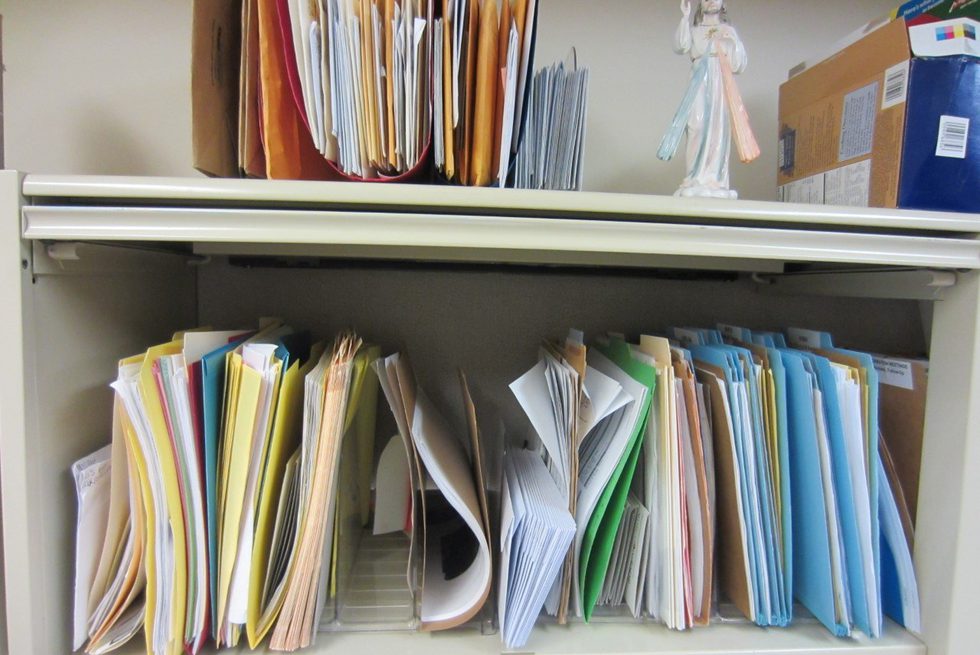 Two shelves of papers at a Chicago adoption agency