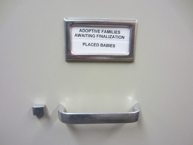 File drawer with label reading, "Adoptive families awaiting finalization. Placed babies"