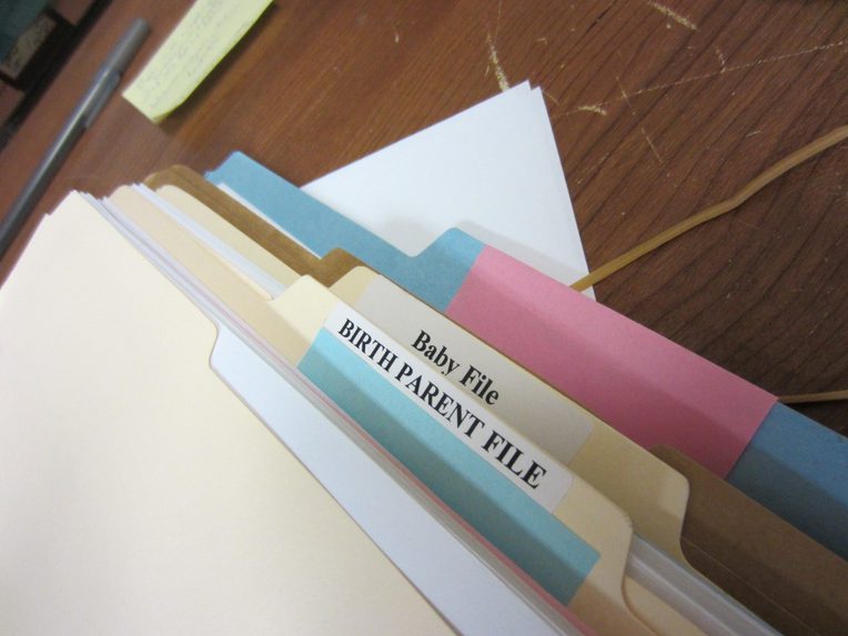 A thick file folder with labels reading, "Baby File" and "Birth Parent File"